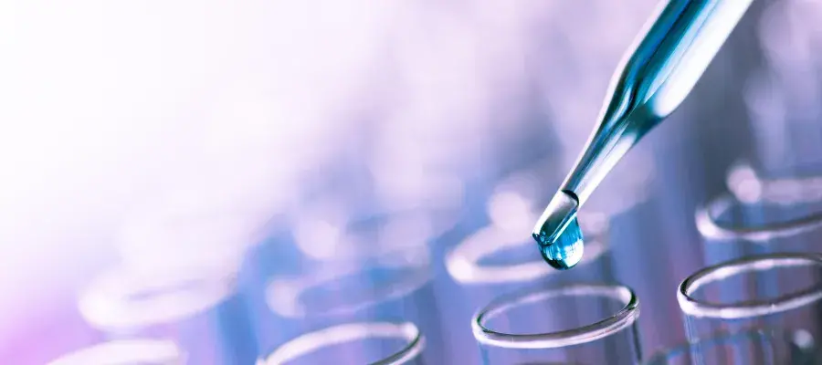 Pipette dropping liquid into test tubes